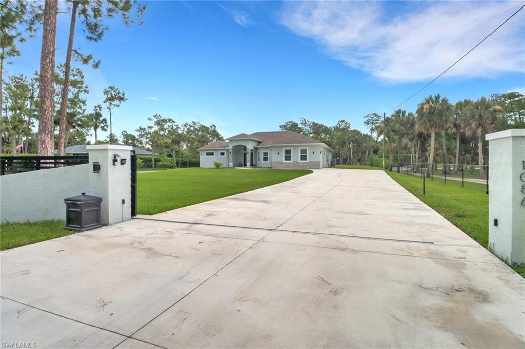 1086 21st Street Southwest Naples, FL 34117 - Photo 3 of 50 a view of a backyard of the house
