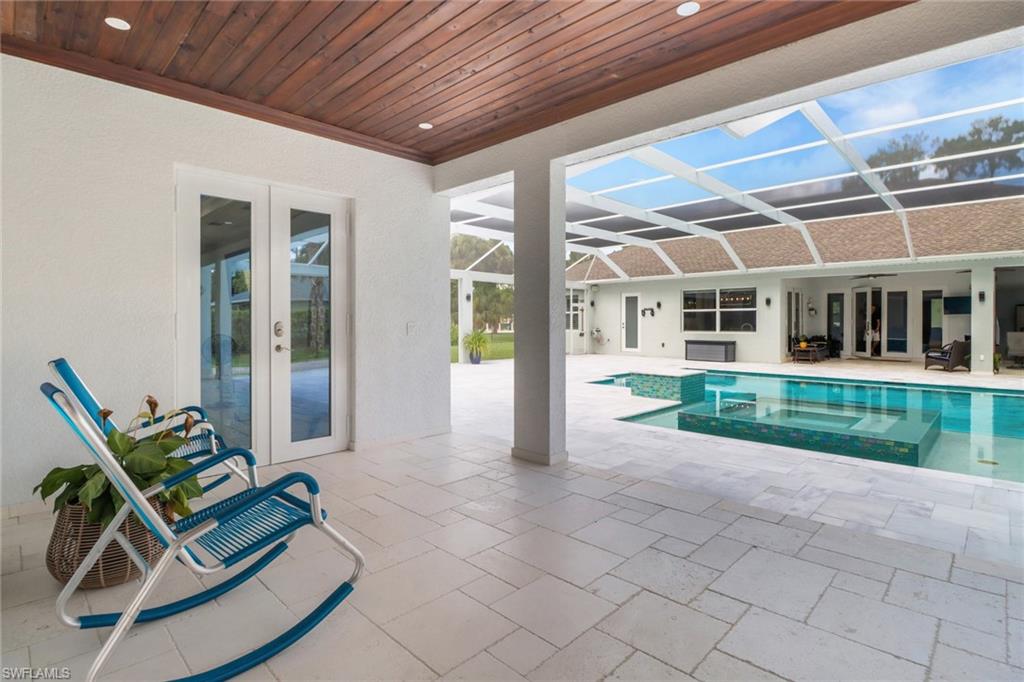 1086 21st Street Southwest Naples, FL 34117 - Photo 31 of 50 a view of a patio with table and chairs and wooden fence