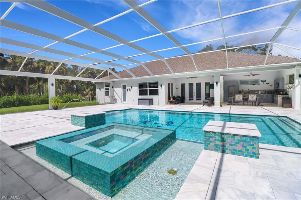 1086 21st Street Southwest Naples, FL 34117 - Photo 32 of 50 a view of a house with a backyard porch and sitting area