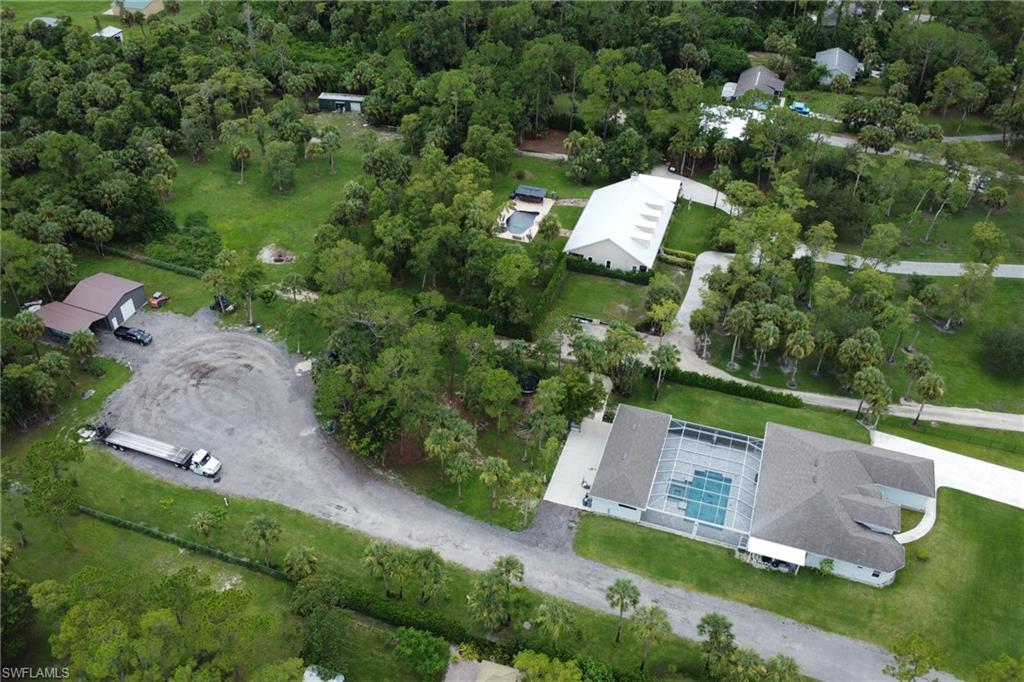 1086 21st Street Southwest Naples, FL 34117 - Photo 47 of 50 an aerial view of a house with a yard and lake view
