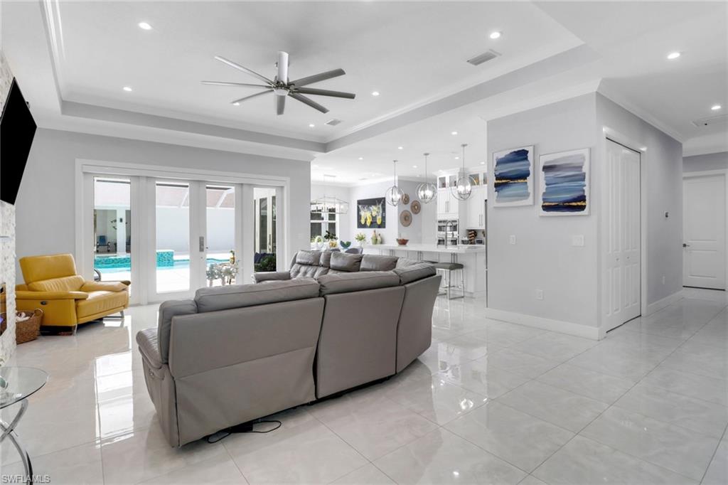 1086 21st Street Southwest Naples, FL 34117 - Photo 8 of 50 a living room with furniture and a large window