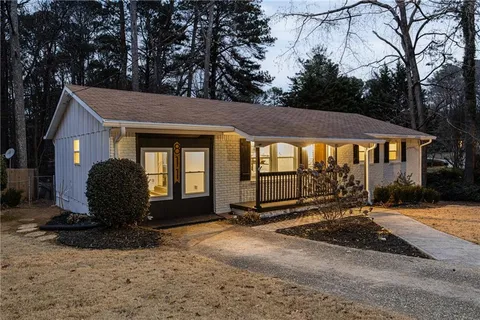 a view of a house with backyard and sitting area