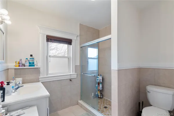 a bathroom with a sink toilet and window