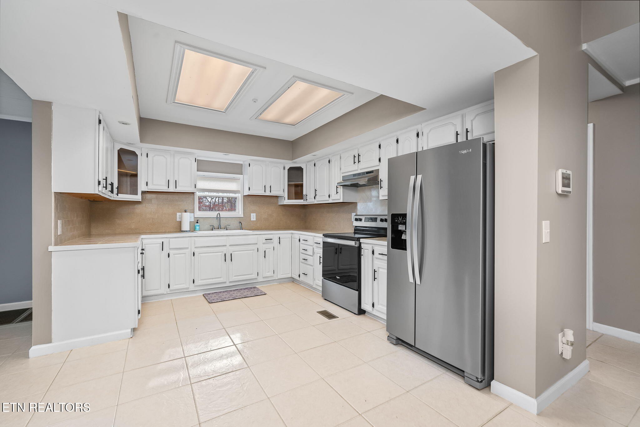 219 North Lowe Road Crossville, TN 38571 - Photo 12 of 34 a kitchen with stainless steel appliances a refrigerator sink and cabinets