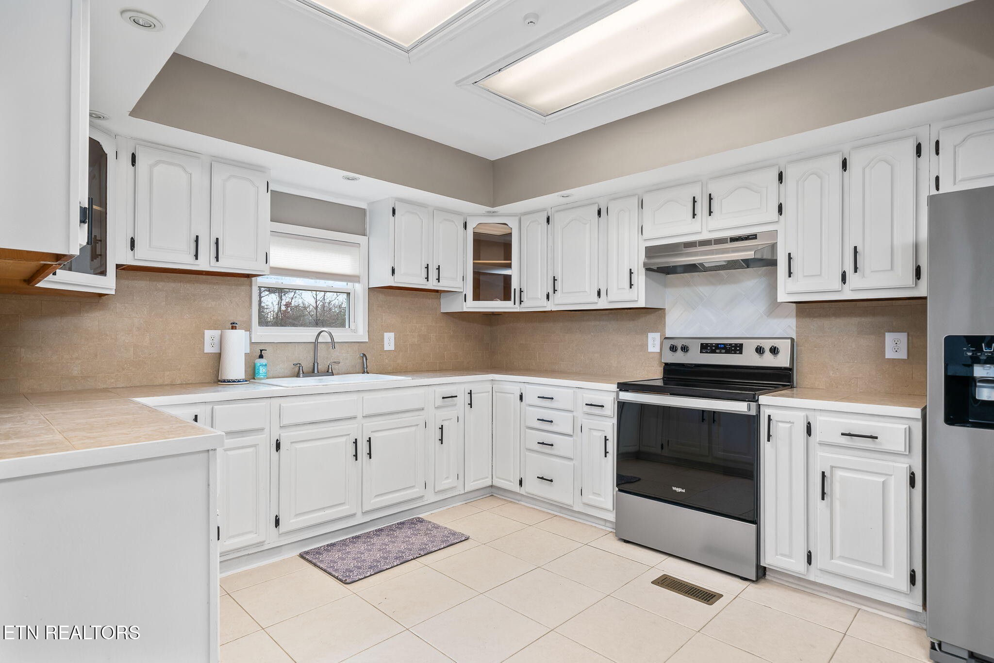 219 North Lowe Road Crossville, TN 38571 - Photo 14 of 34 a kitchen with cabinets appliances and a sink