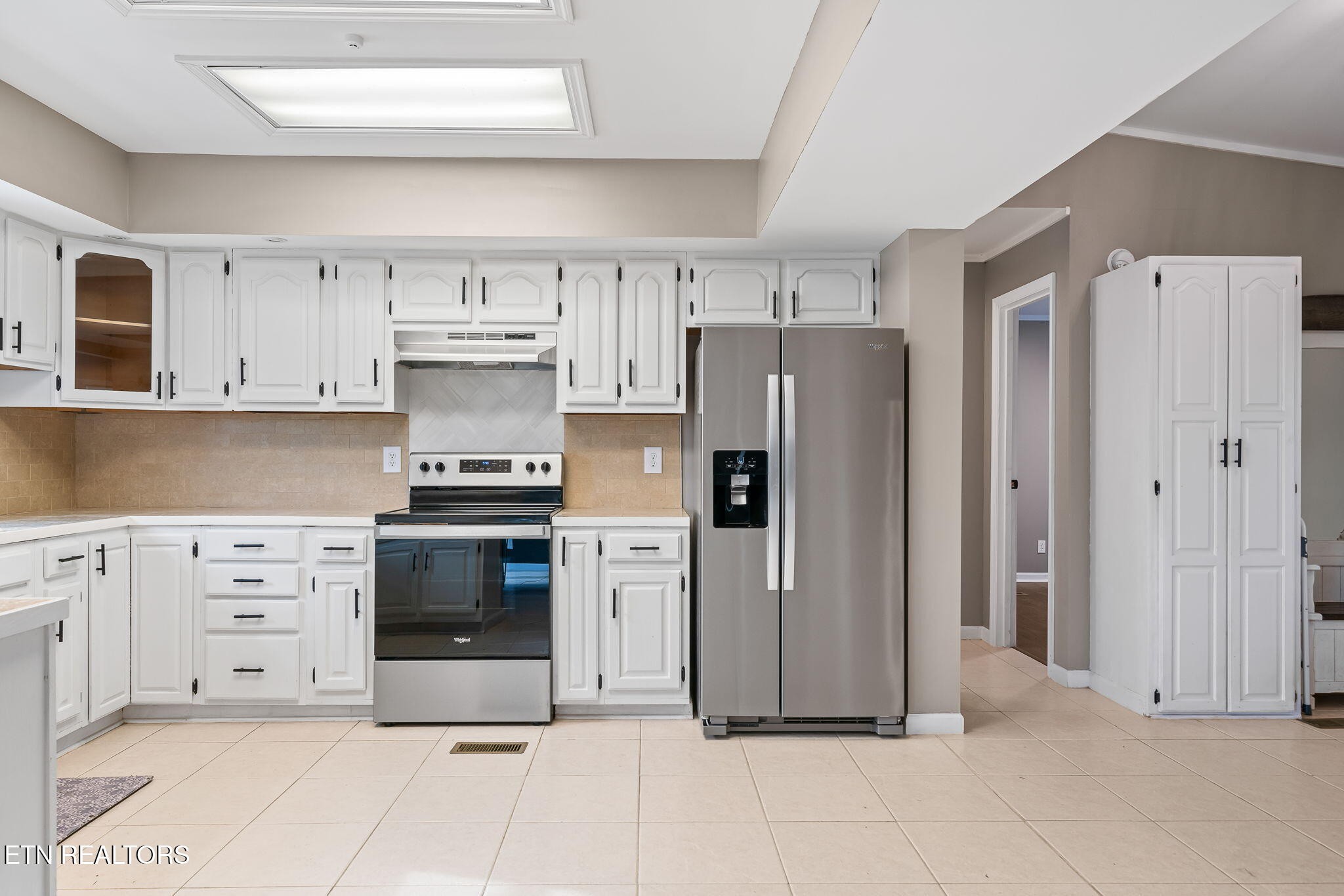 219 North Lowe Road Crossville, TN 38571 - Photo 15 of 34 a kitchen with stainless steel appliances a refrigerator stove and white cabinets