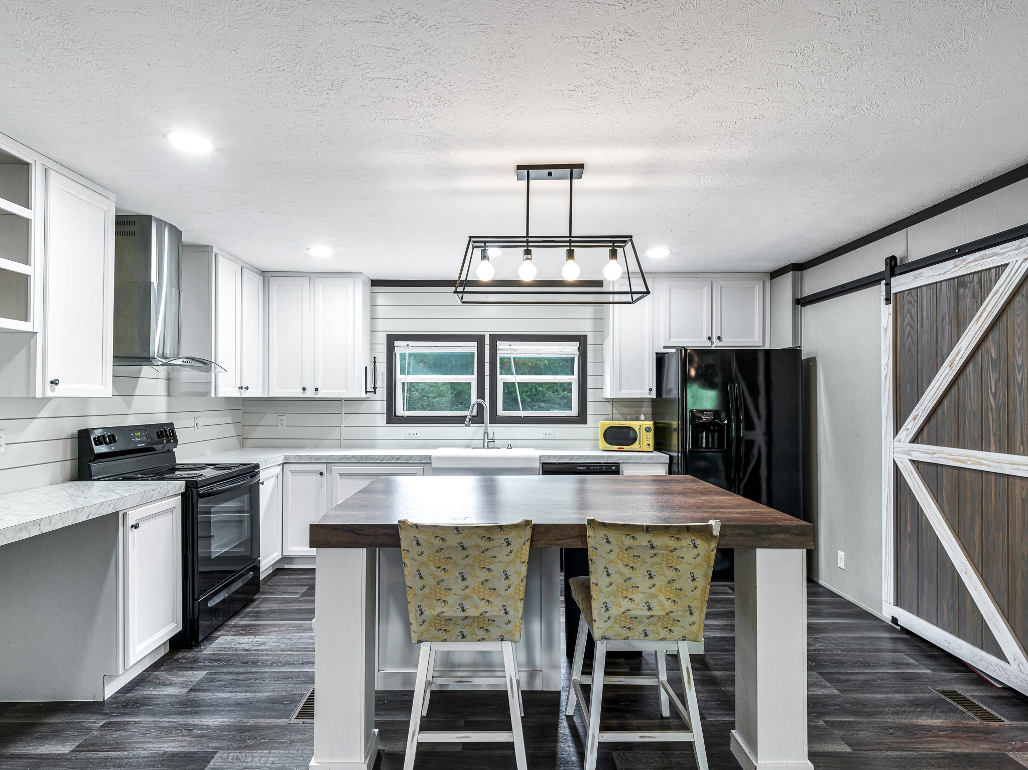 1047 Jimbob Lane New Ulm, TX 78950 - Photo 4 of 18 Featuring a large island with rustic wood style countertop, providing a perfect workspace or breakfast bar!