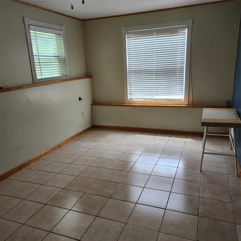 an empty room with a window and a mirror