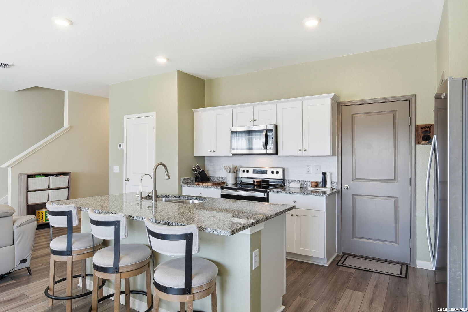 5496 Rue Girard Converse, TX 78109 - Photo 11 of 40 a kitchen with a sink cabinets and wooden floor
