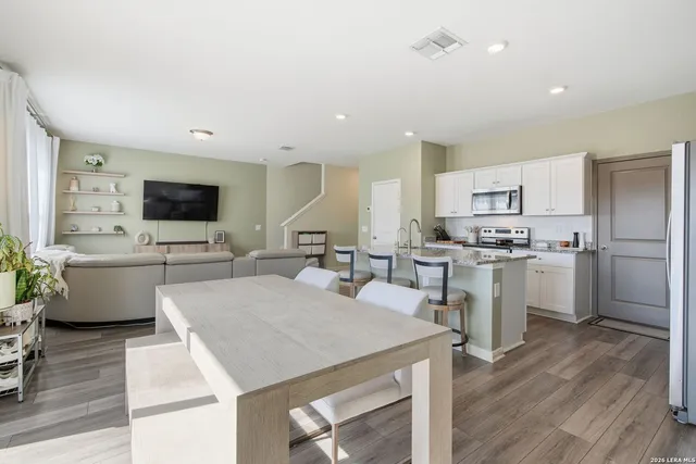 a open kitchen with white cabinets and stainless steel appliances
