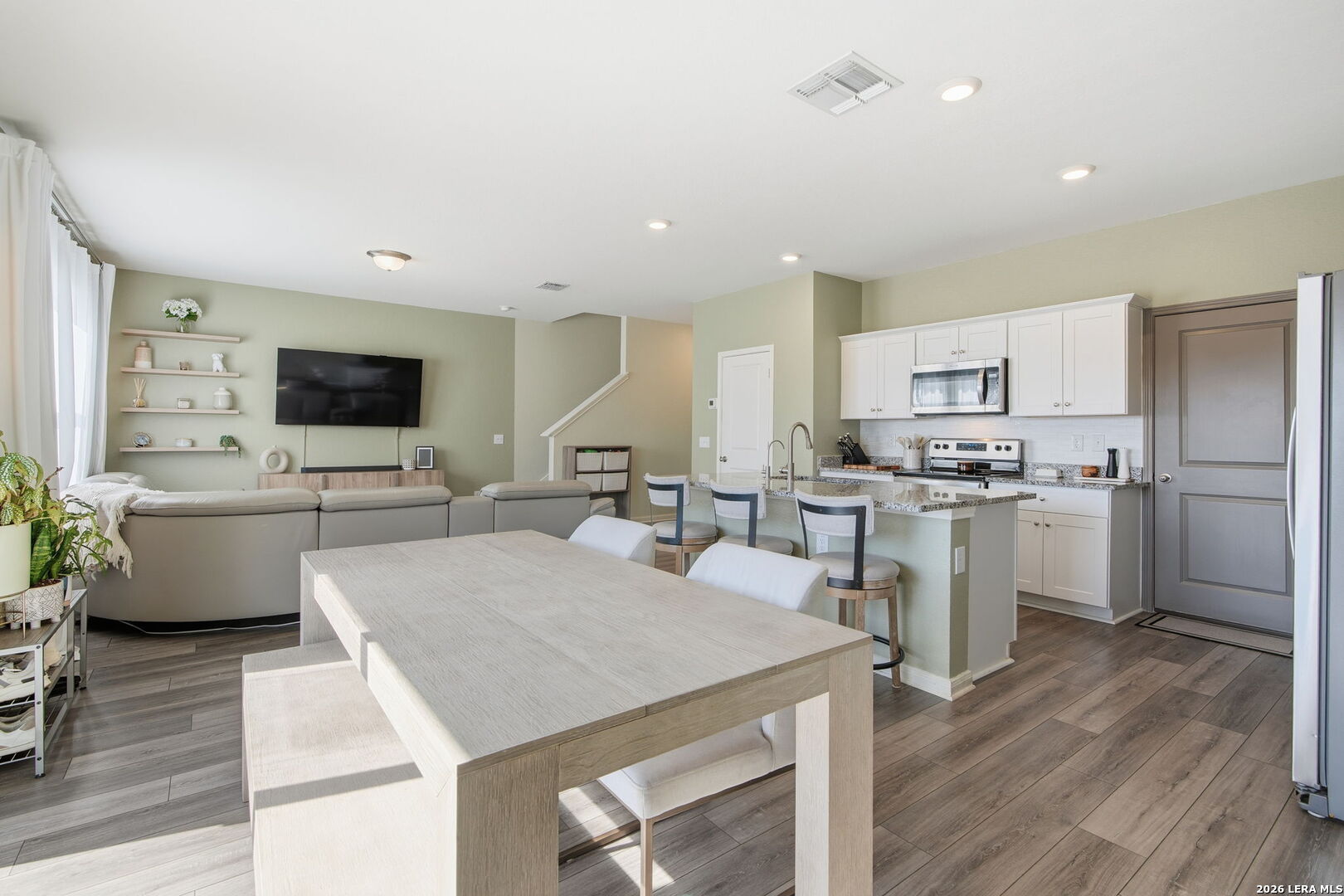 5496 Rue Girard Converse, TX 78109 - Photo 14 of 40 a open kitchen with white cabinets and stainless steel appliances