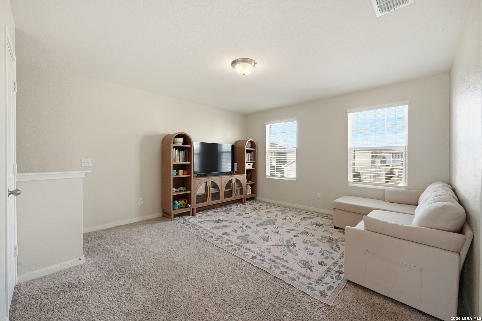 5496 Rue Girard Converse, TX 78109 - Photo 18 of 40 a living room with furniture and a flat screen tv