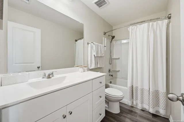 a bathroom with a sink toilet a shower and a mirror