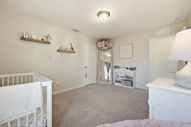 a bedroom with a bed and a chair