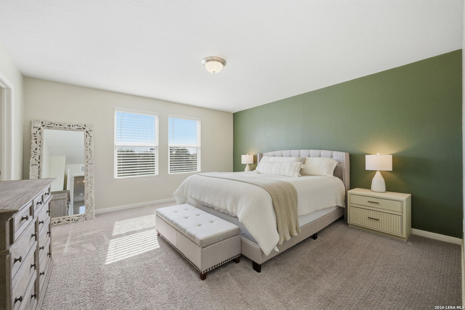 5496 Rue Girard Converse, TX 78109 - Photo 25 of 40 a spacious bedroom with a bed a table and windows