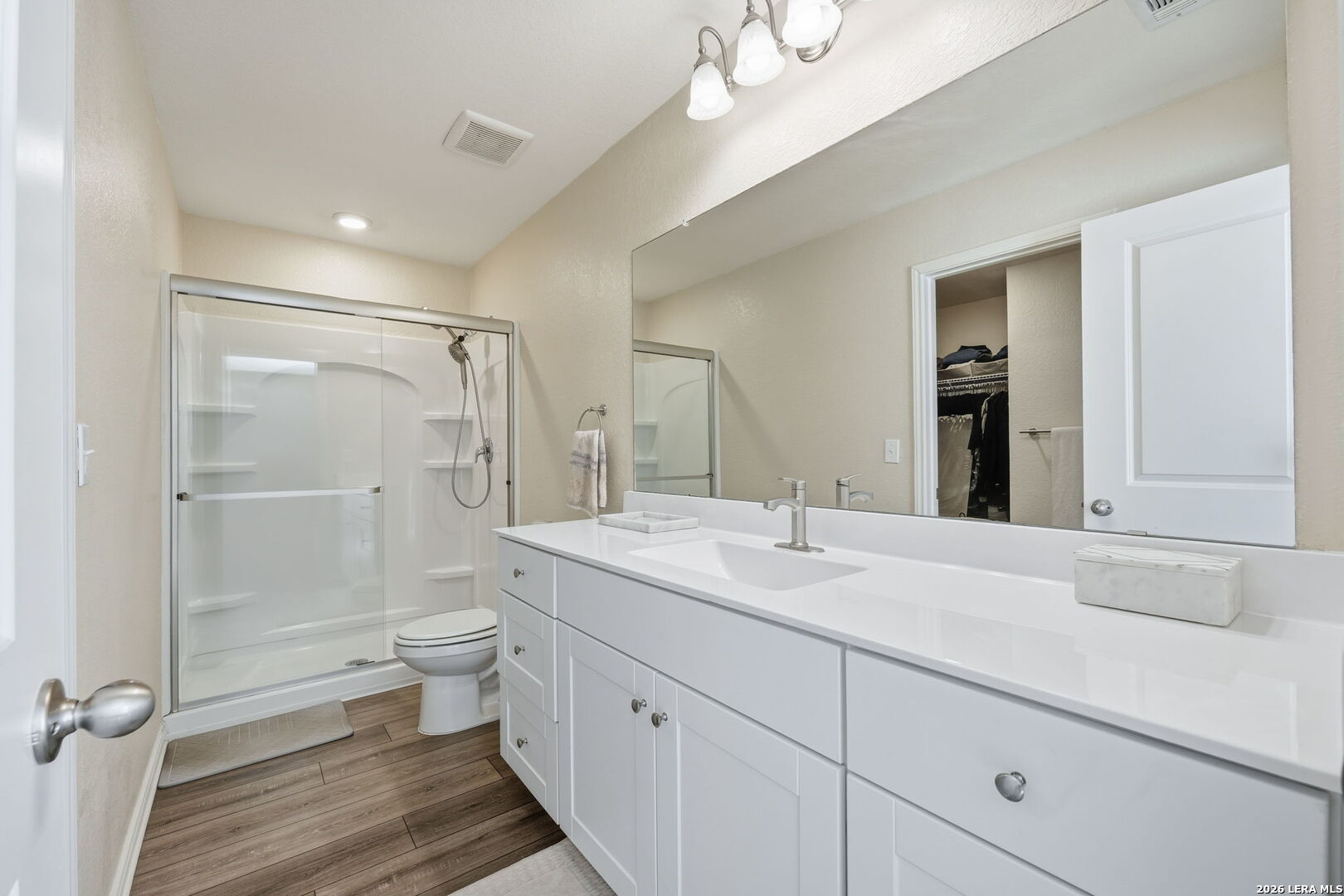 5496 Rue Girard Converse, TX 78109 - Photo 27 of 40 a bathroom with a toilet a sink a mirror and a shower