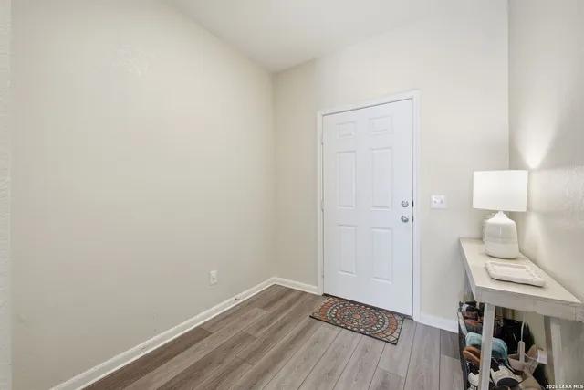 a view of a room with wooden floor and glass door