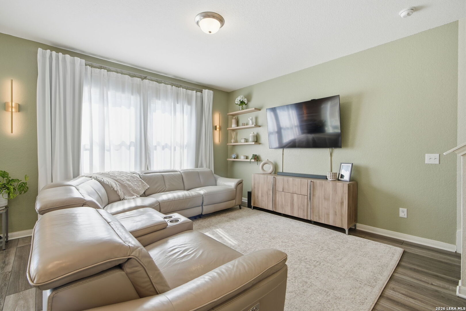 5496 Rue Girard Converse, TX 78109 - Photo 7 of 40 a living room with furniture and a flat screen tv