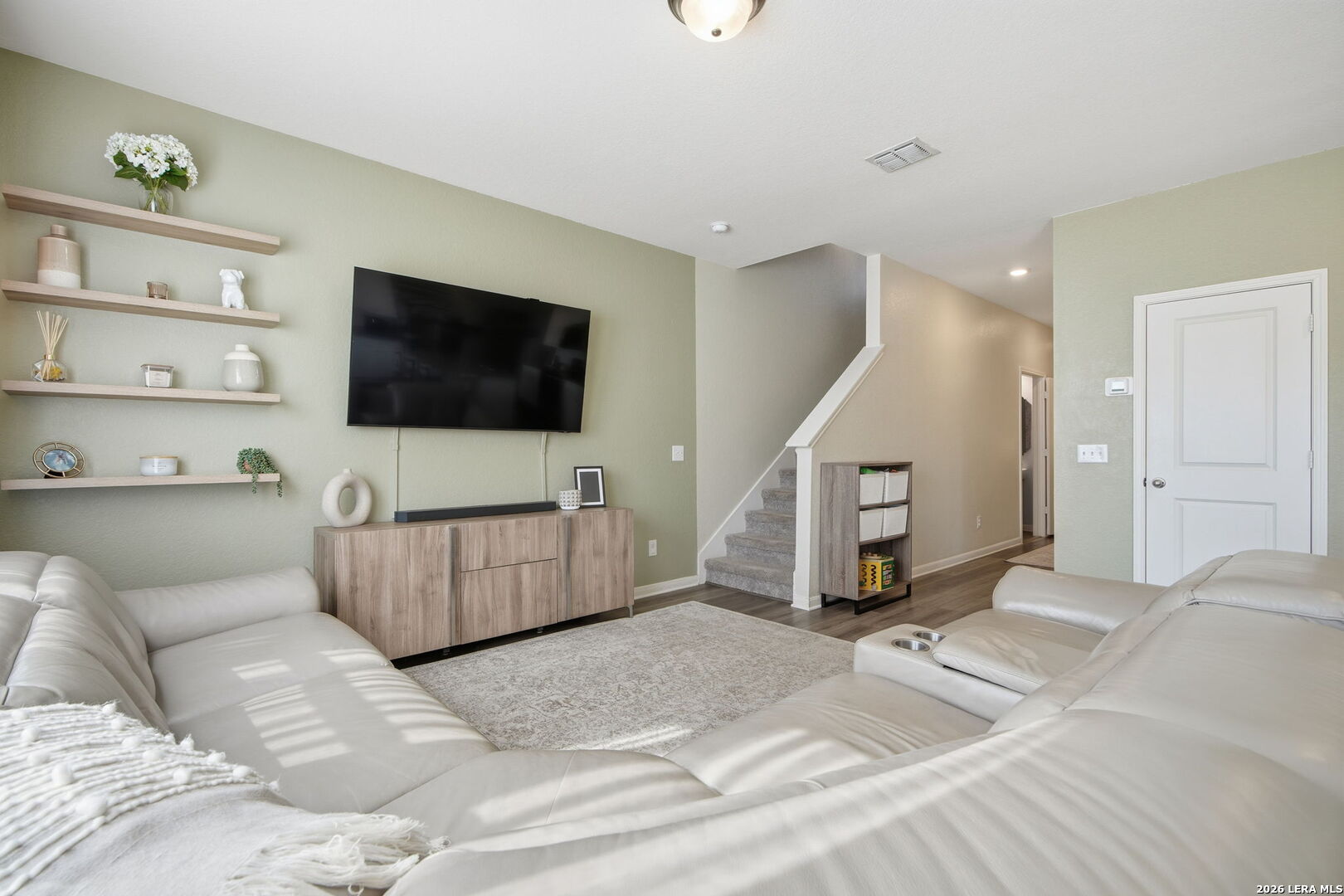 5496 Rue Girard Converse, TX 78109 - Photo 8 of 40 a living room with a couch and a flat screen tv