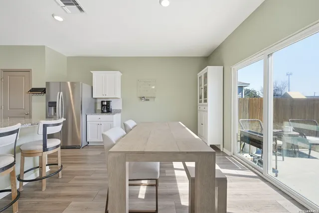 a kitchen with stainless steel appliances kitchen island granite countertop a refrigerator and cabinets