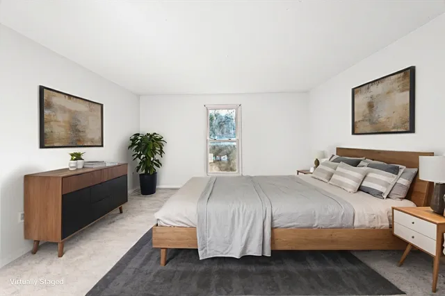 a bedroom with a bed and a flat screen television