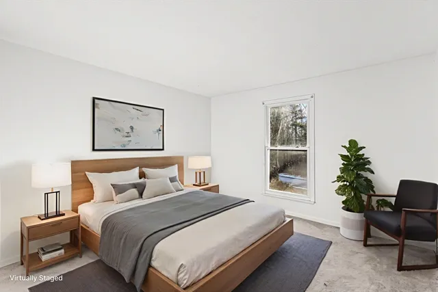 a bedroom with a bed and a potted plant