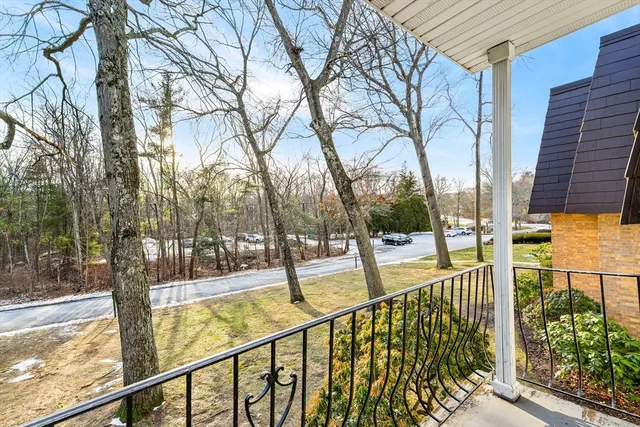 a view of balcony with wooden floor and fence