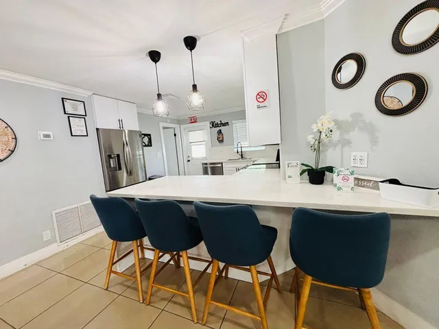 a kitchen with a dining table and chairs