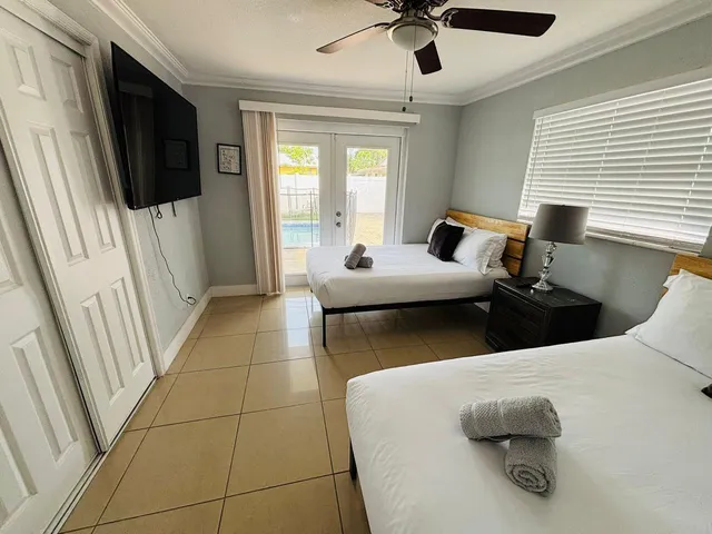 a bedroom with a bed and flat screen tv