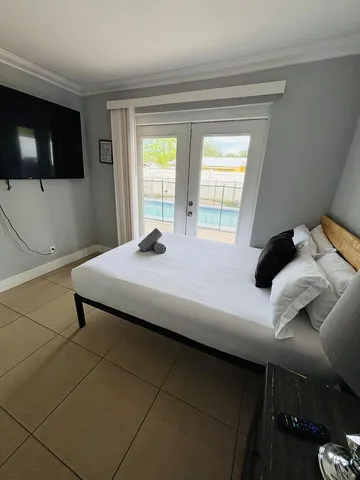 a bedroom with a bed and a flat screen tv