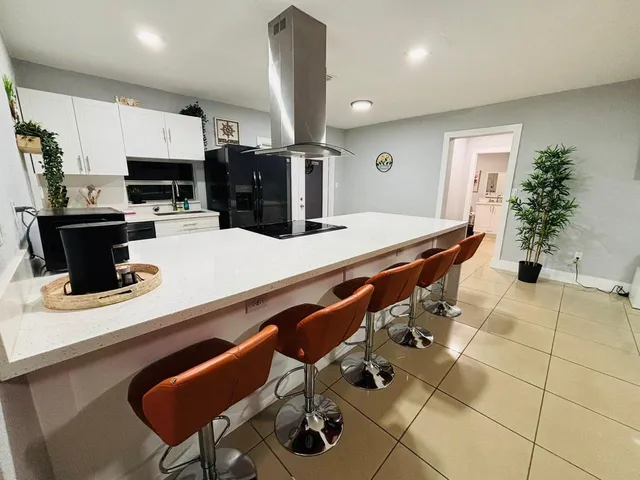 a kitchen with stainless steel appliances kitchen island granite countertop a sink and cabinets