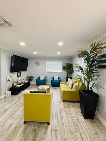 a living room with furniture fireplace and flat screen tv