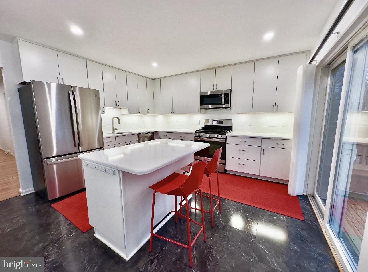 4203 Main Street Alexandria, VA 22309 - Photo 2 of 6 a kitchen with stainless steel appliances granite countertop a refrigerator a stove a sink and a microwave