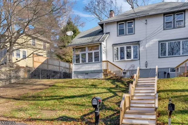 a view of a house with backyard and sitting area