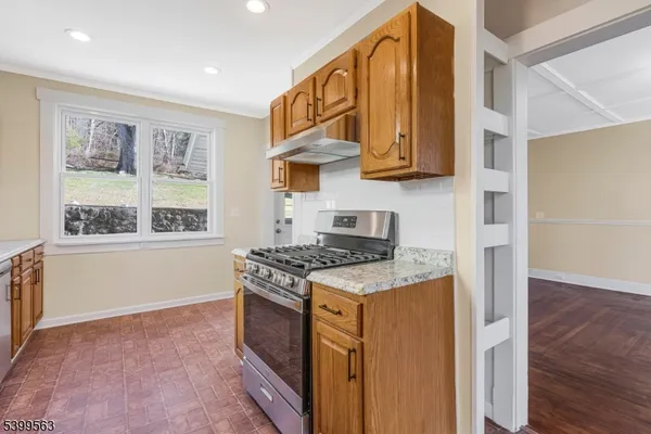 a kitchen with stainless steel appliances granite countertop a stove and a refrigerator