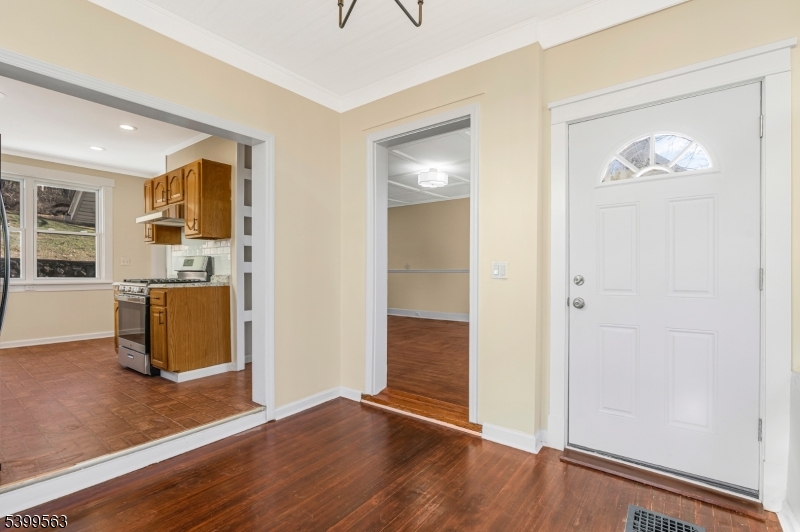 16 Tisco Avenue High Bridge, NJ 08829 - Photo 4 of 28 an empty room with wooden floor and kitchen view
