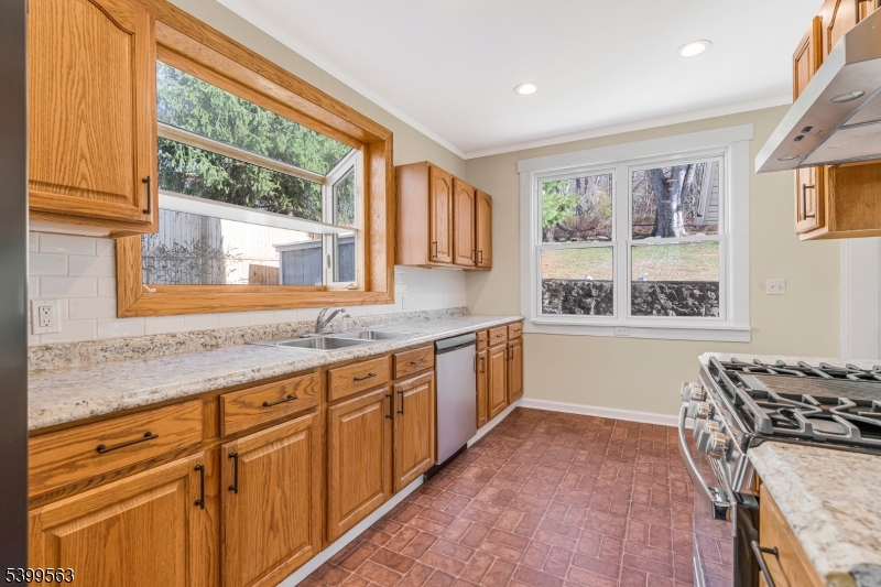 16 Tisco Avenue High Bridge, NJ 08829 - Photo 7 of 28 a kitchen with granite countertop a stove a sink and a wooden cabinets