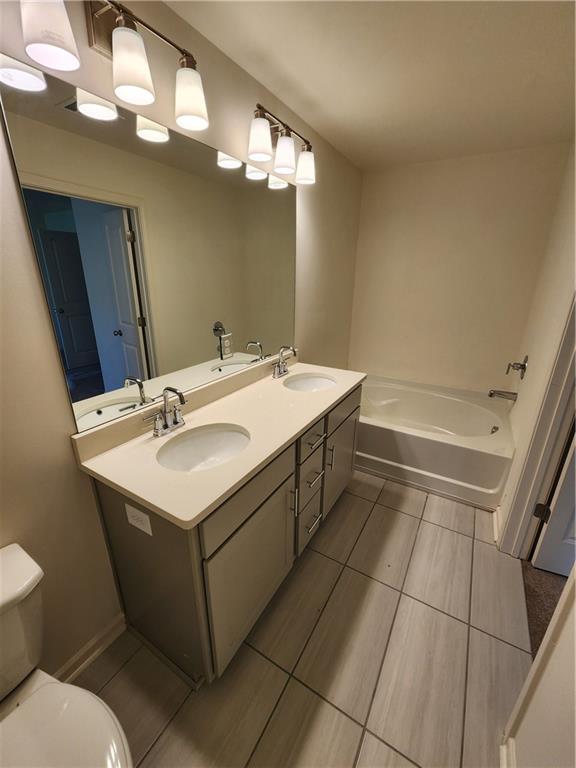 4237 Spring Valley Circle Tucker, GA 30084 - Photo 7 of 7 a bathroom with a sink a toilet and mirror