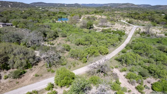 an aerial view of mountains residential house and green space