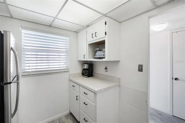 a kitchen with cabinets appliances and a window