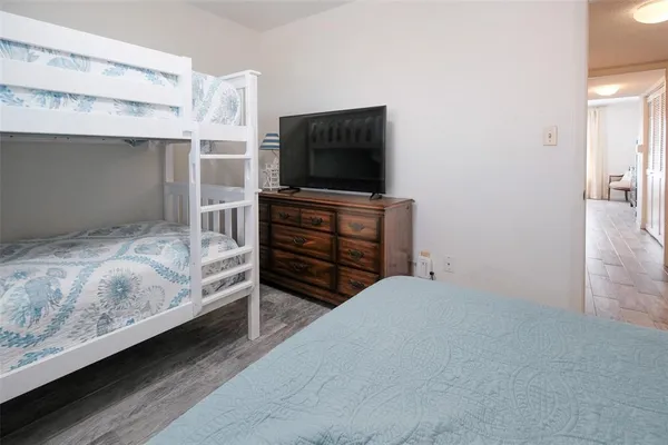 a bedroom with a bed and flat screen tv