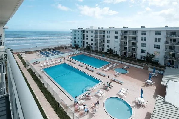 a view of a swimming pool with outdoor seating