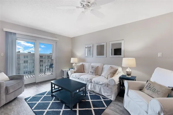 a living room with furniture and a floor to ceiling window