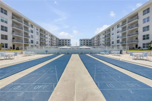 a roof deck with table and chairs