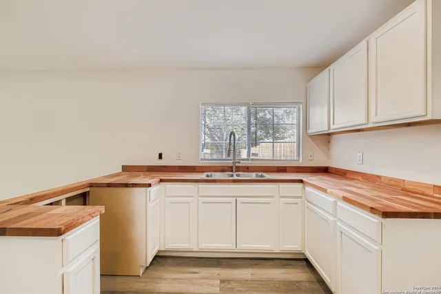 a kitchen with a sink and cabinets