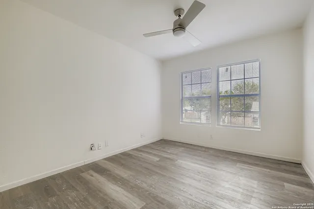 an empty room with a empty space and windows