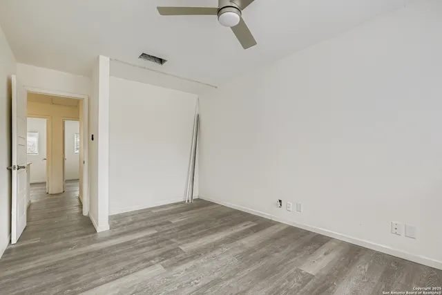 a view of a room with wooden floor