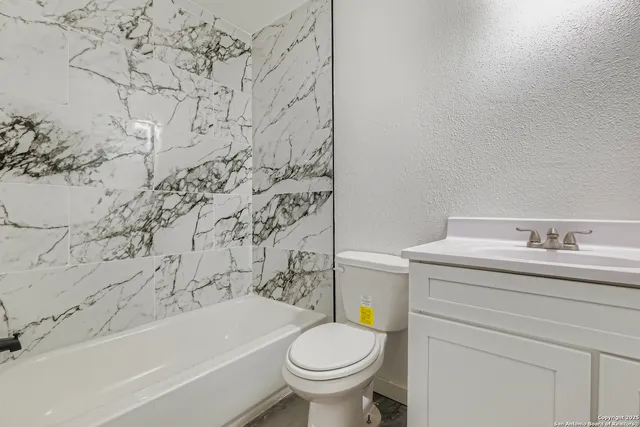 a bathroom with a sink toilet and bathtub