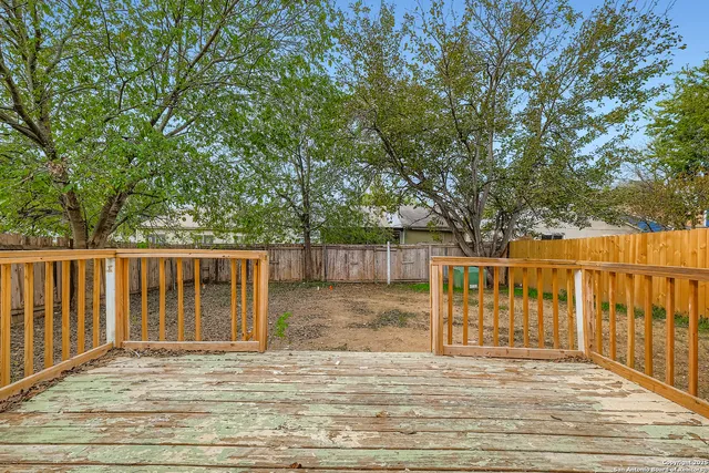 a balcony with wooden floor and fence