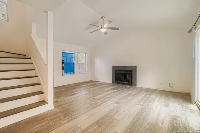 wooden floor in an empty room with a fireplace